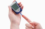 Image of blood glucose monitor and finger